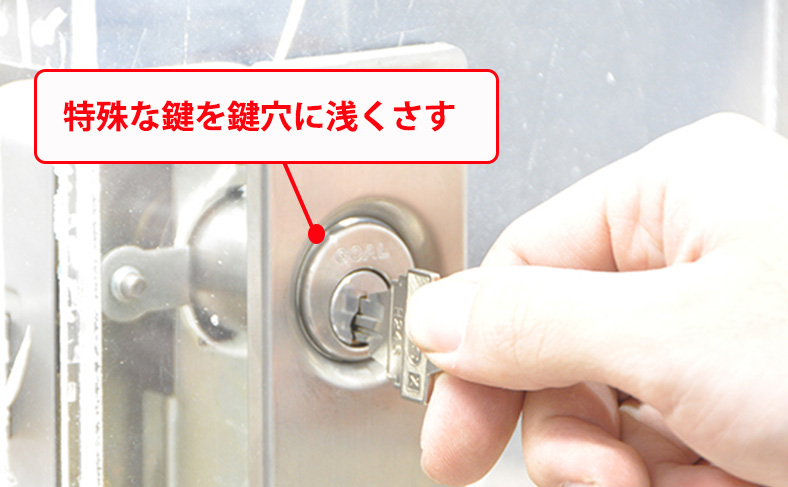 特殊な鍵を鍵穴に浅く挿す